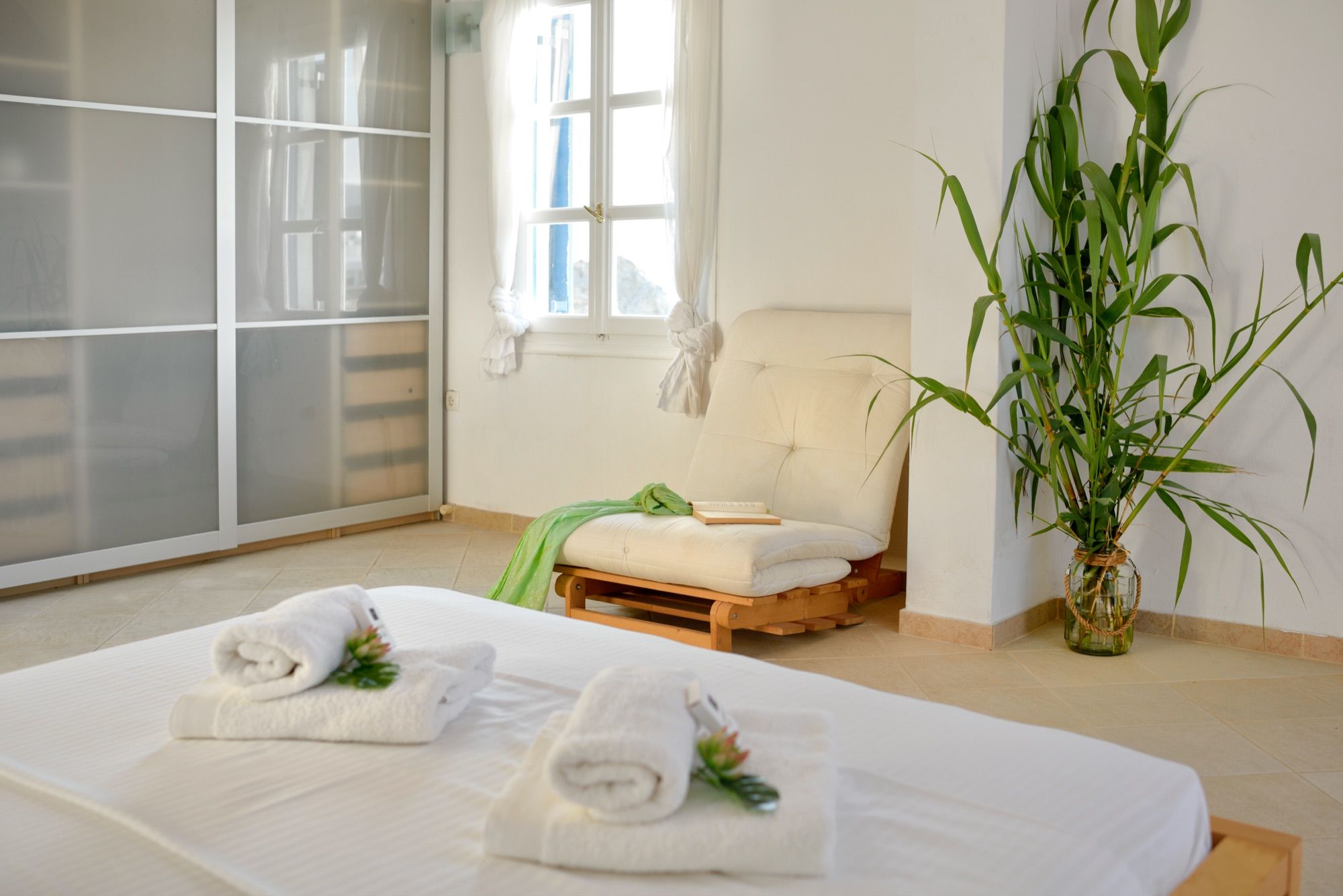 Bedroom with fresh towels on white linen