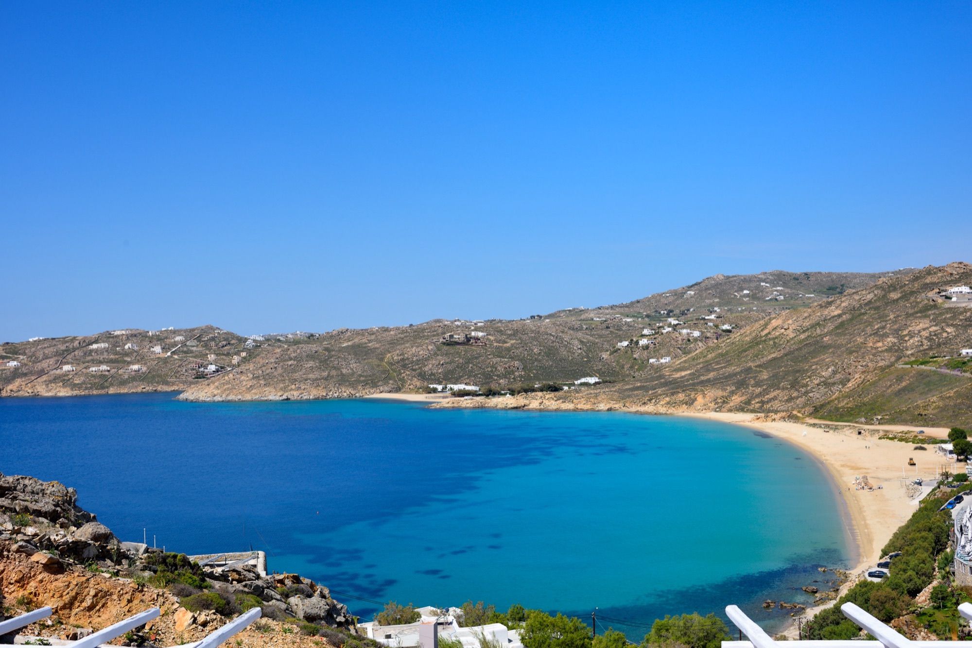 View over the curved bay and sandy beach of Elia, Mykonos, from the villa