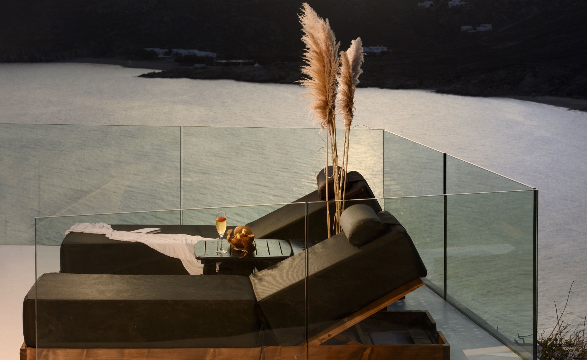 Double lounger with pampas grass at dusk