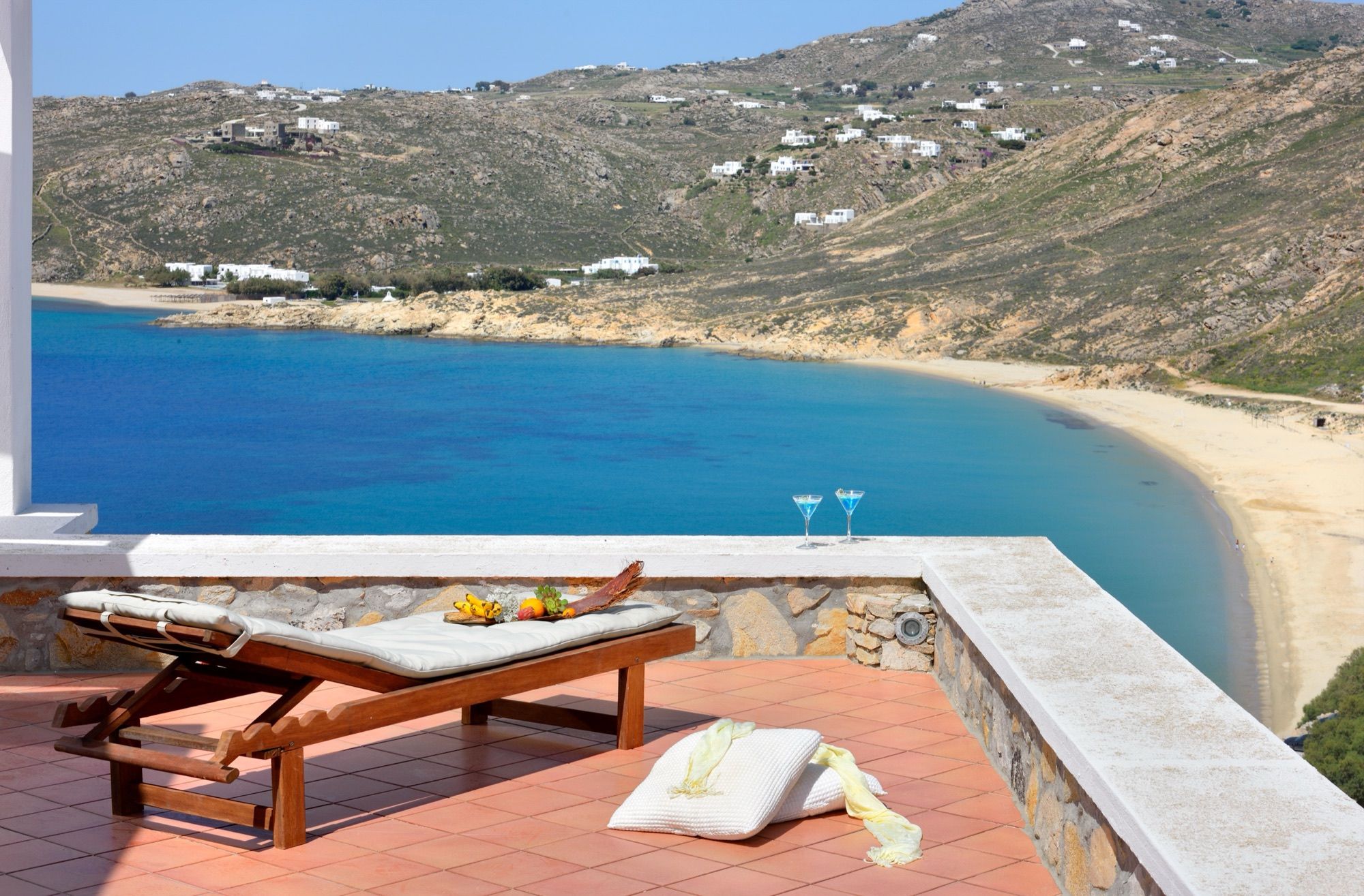 Sunbed on a terrace overlooking the curve of Elia Beach
